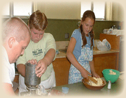 Children making cookies from scratch.